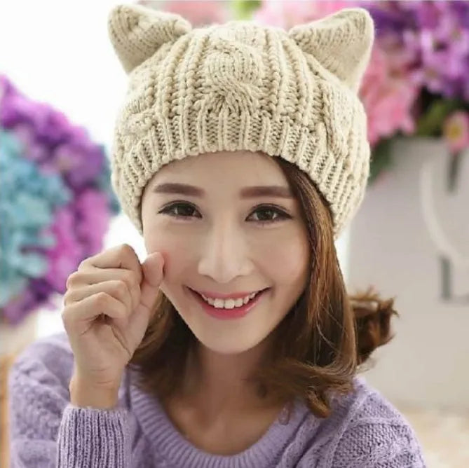 Hand-made chunky wool beanie with 3D knitted cat ears on a white background.