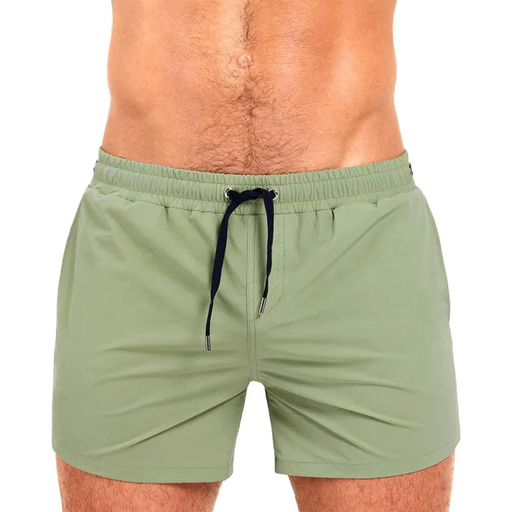 Men's solid colour swimming shorts with mesh lining for sports and fitness activities