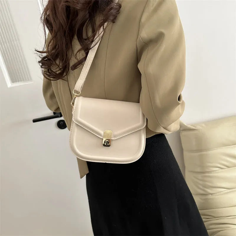 Soft PU shoulder messenger bag in horizontal square clamshell shape with niche texture.