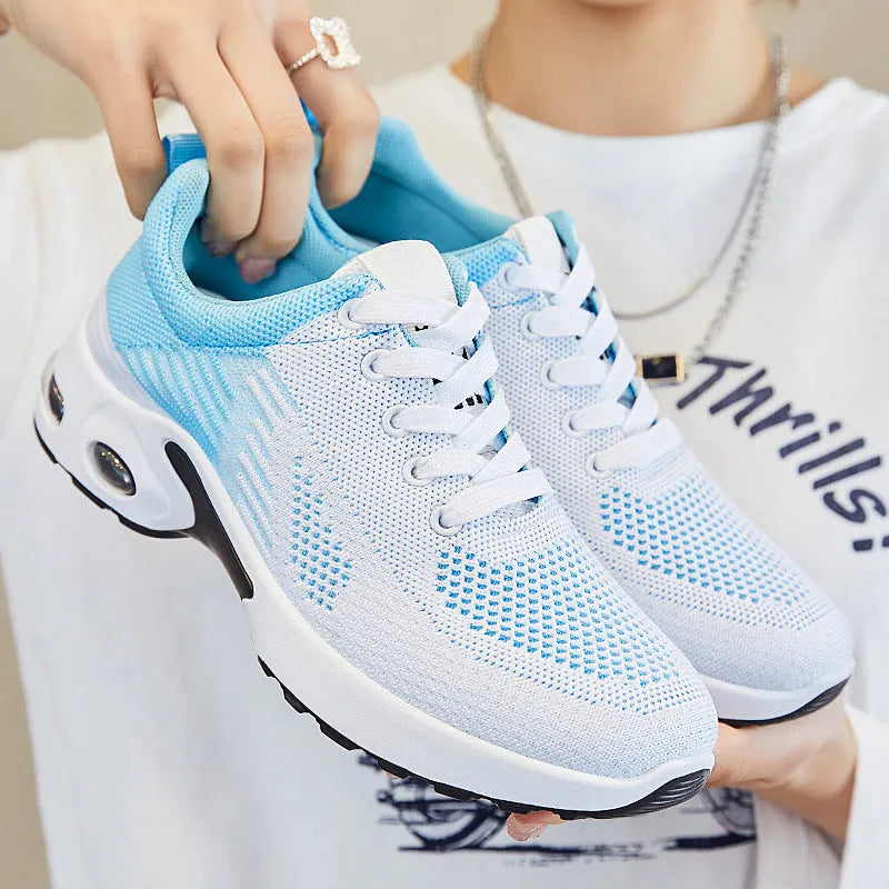 Women's pink Flyknit casual running shoes with mesh lining and flat heel on a white background
