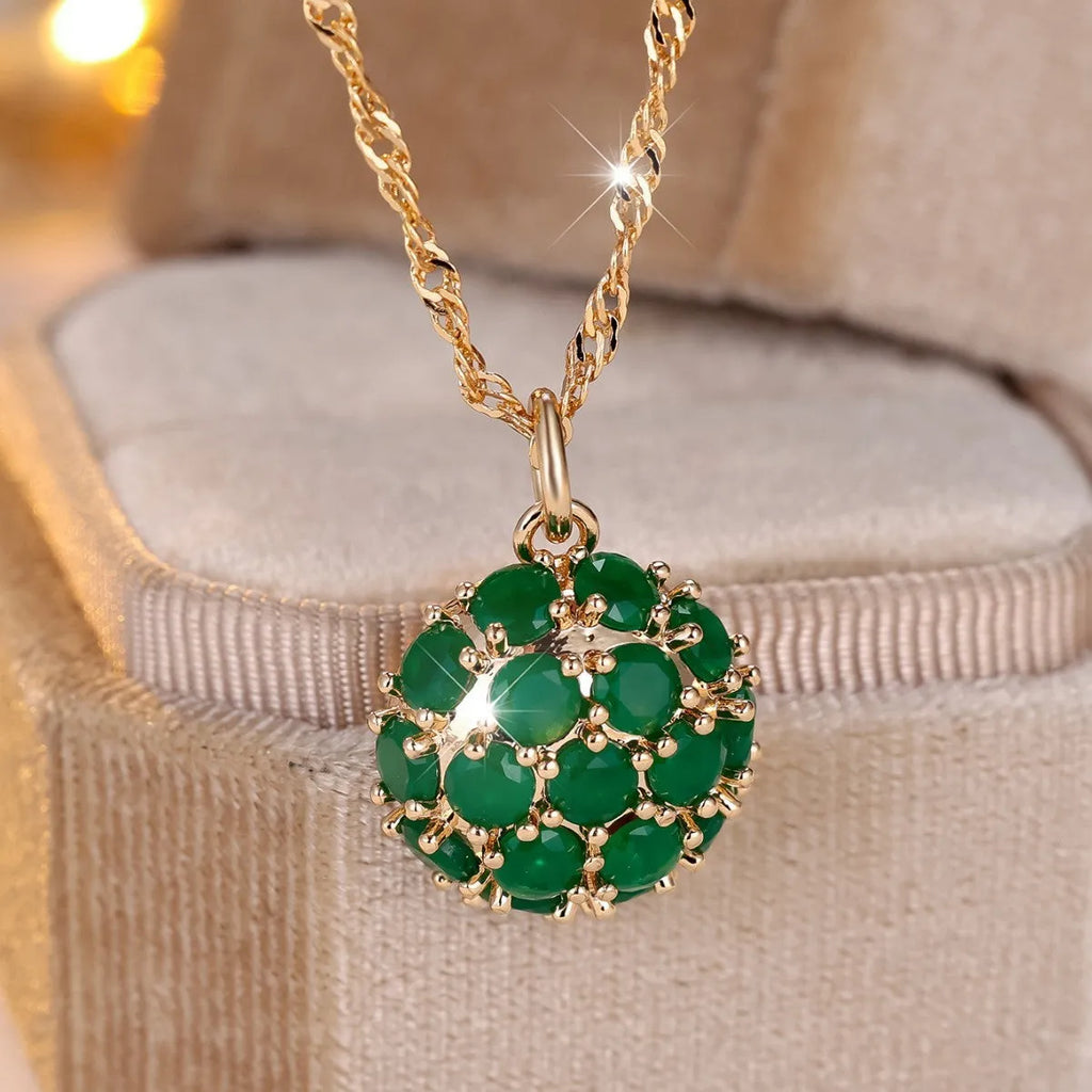Women's champagne gold necklace with round emerald pendant and diamond accents on copper chain