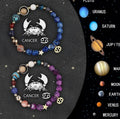 Set of two natural stone beaded bracelets with metal zodiac charms on a dark background.