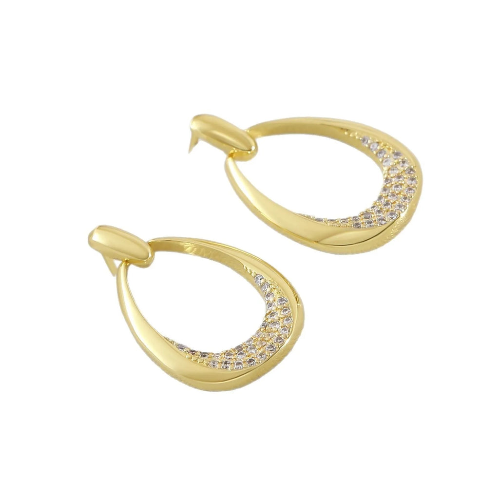 Yellow gold geometric drop earrings for women with round and oval elements, shown with handbag packaging.