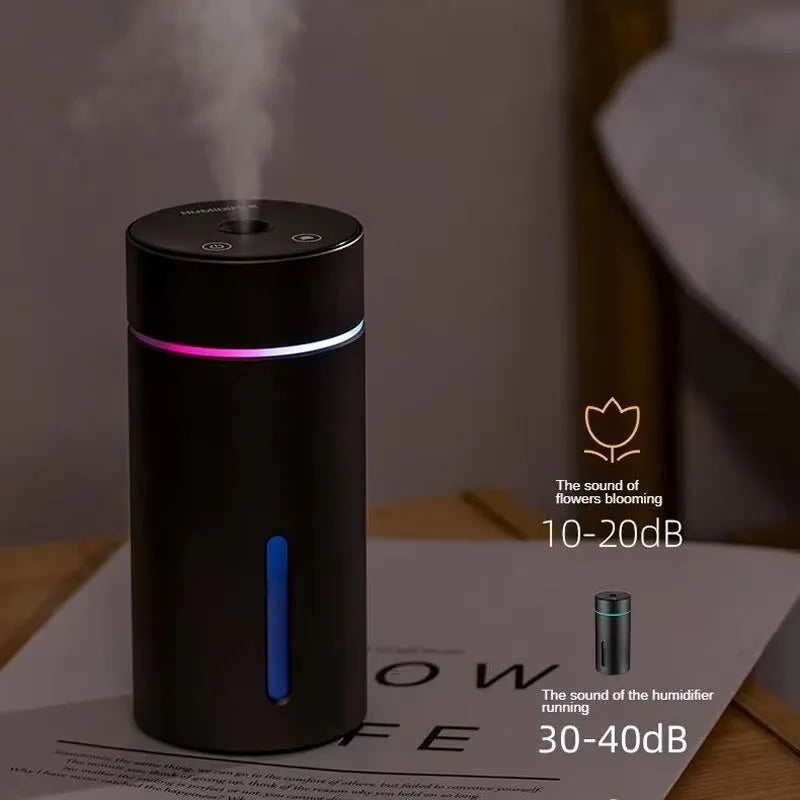 Black aluminium car humidifier and essential oil diffuser with colourful night light on, 66mm wide.