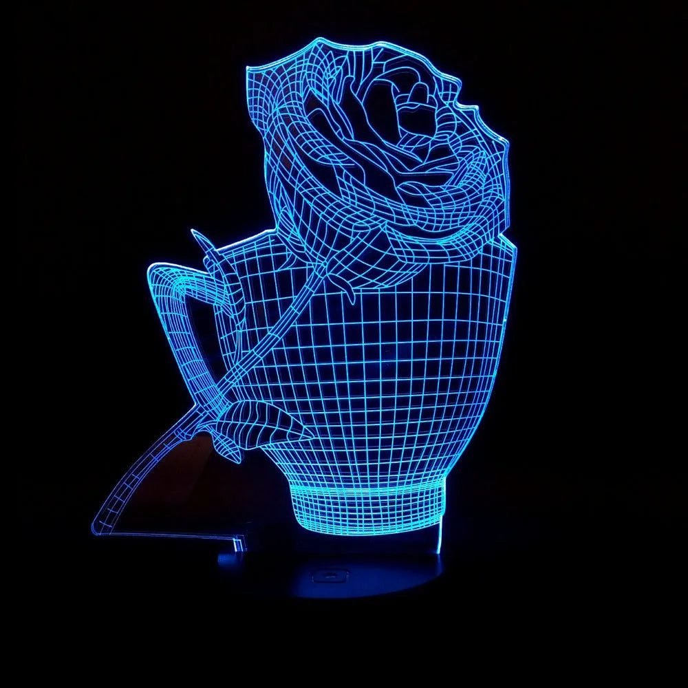 3D rose design acrylic night light with ABS base on a table, showing multi-coloured LED illumination.