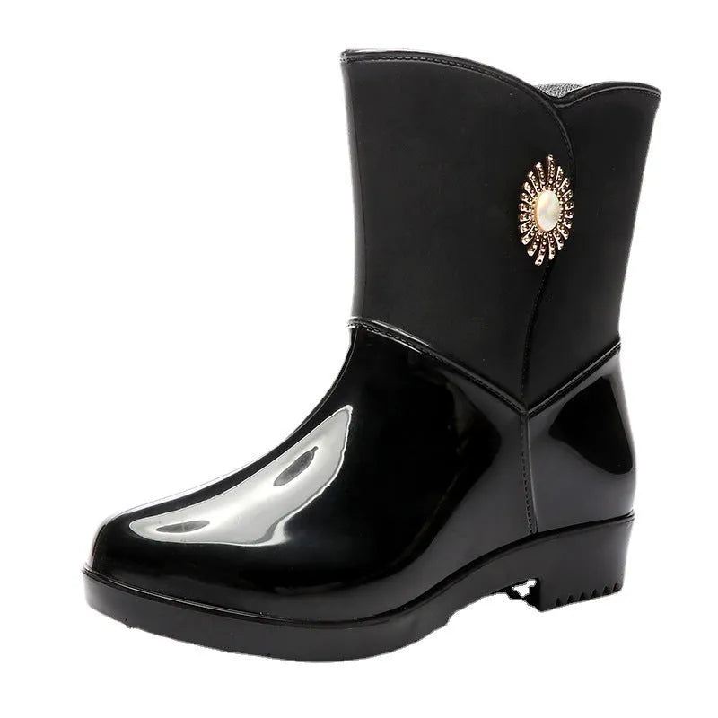Women's purple rain boot with middle tube height and textured non-slip sole.