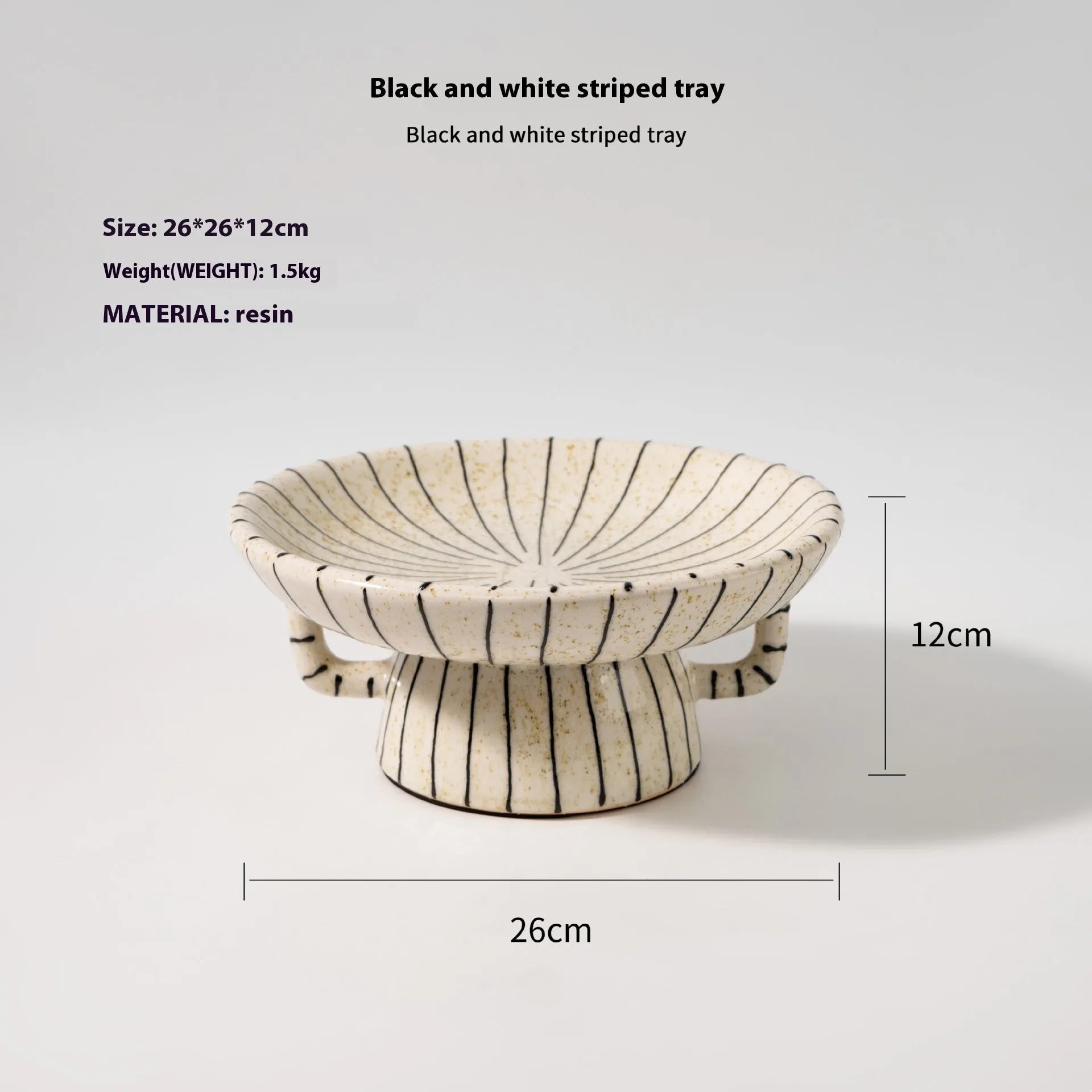 Black and white striped resin fruit plate on a table for dessert serving.