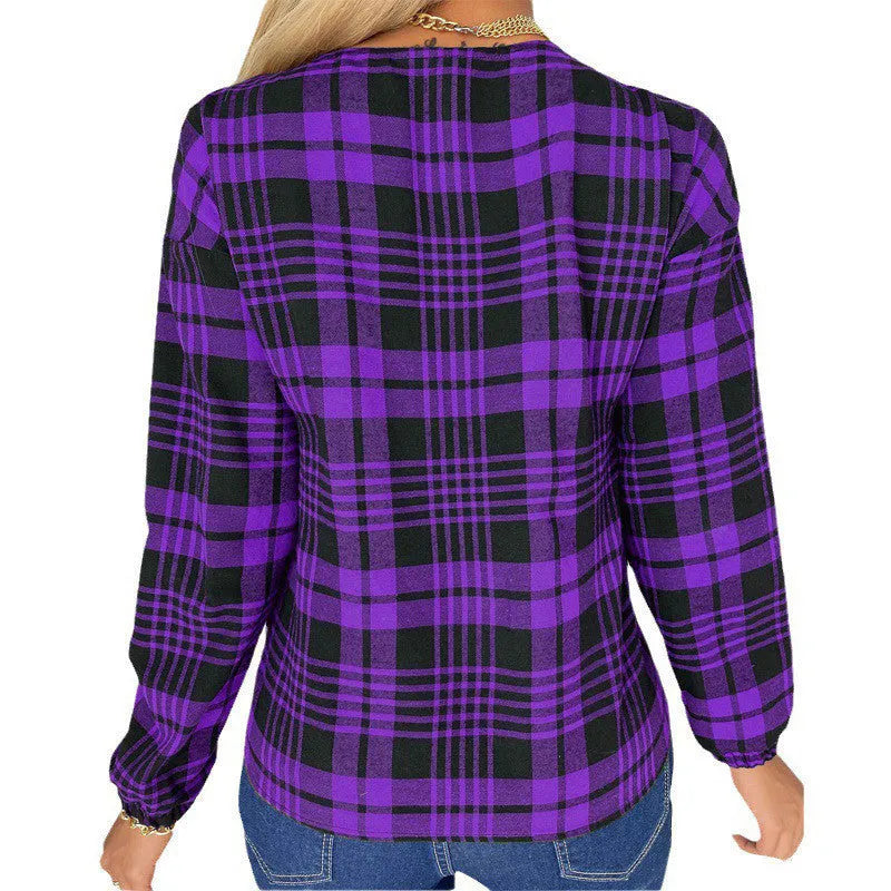 Women's purple loose fit plaid shirt with regular sleeves on a hanger.