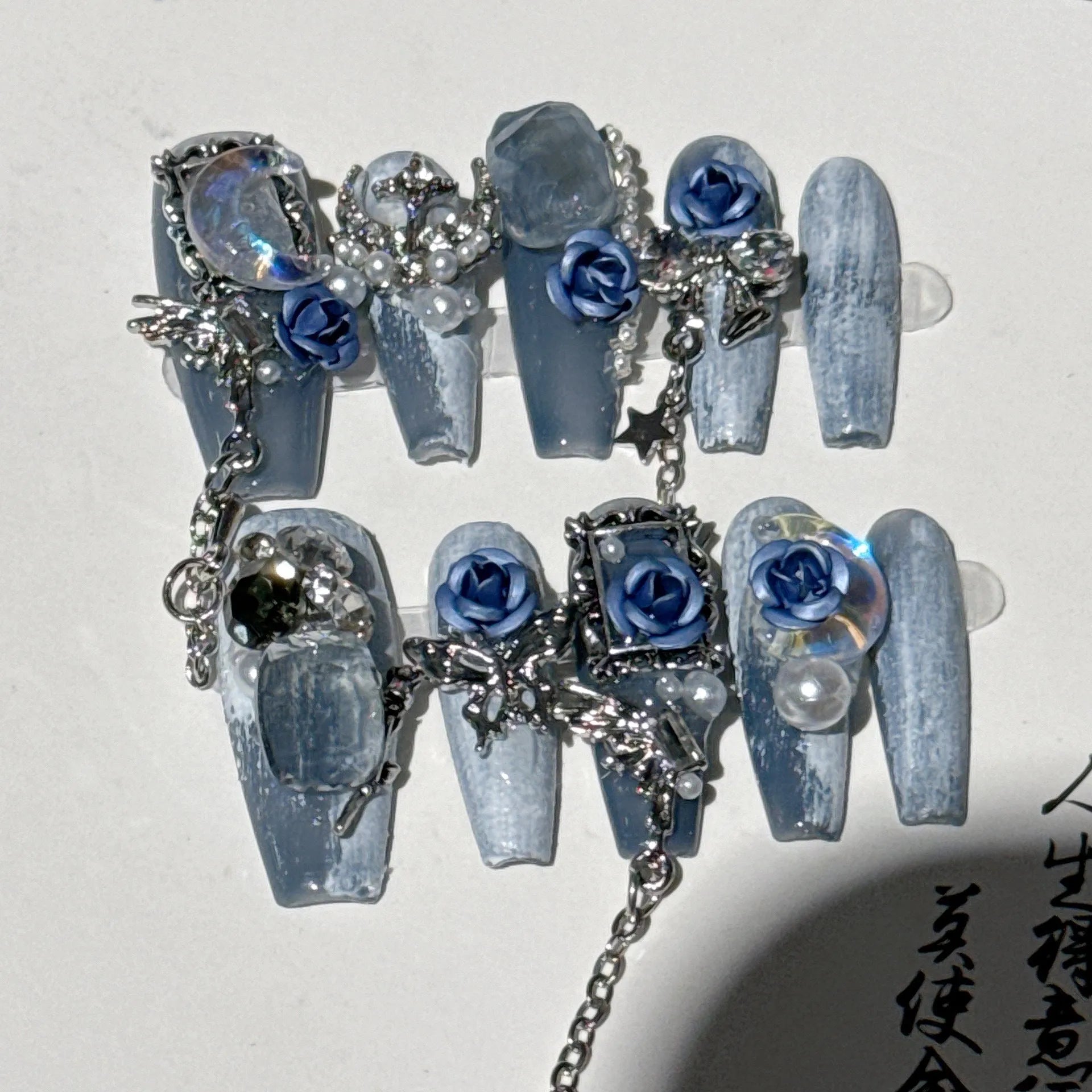 Reusable blue floral press-on nails with rose pattern in sizes XS, S, M, L