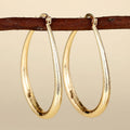 Women's geometric drop earrings with clip-on fastening in copper with ring and line design elements