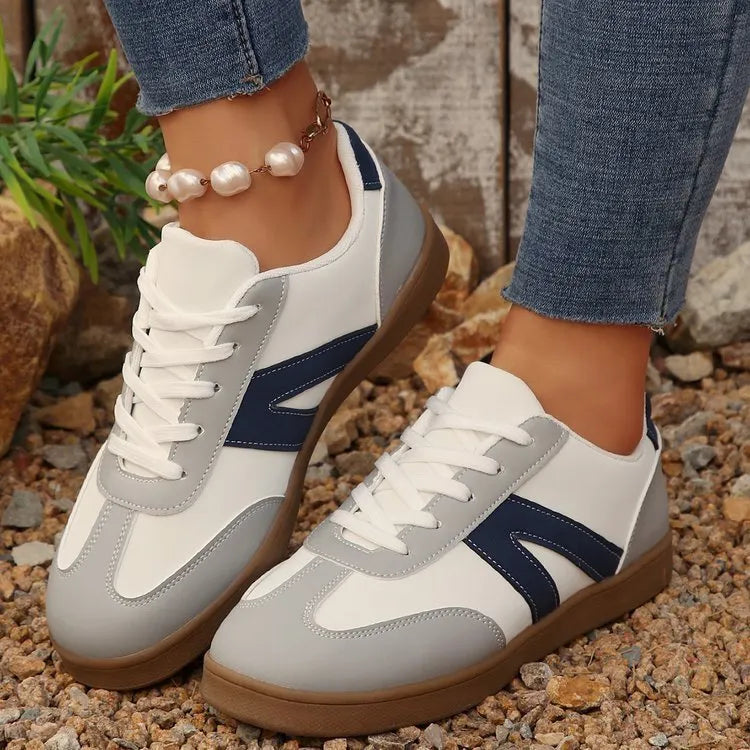 Blue women's flat German training shoes with lace-up front and rubber sole.