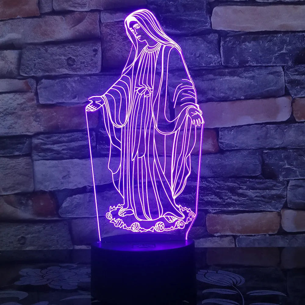 3D LED night light with colourful dual-ring pattern, remote control, and USB cable on a desk.