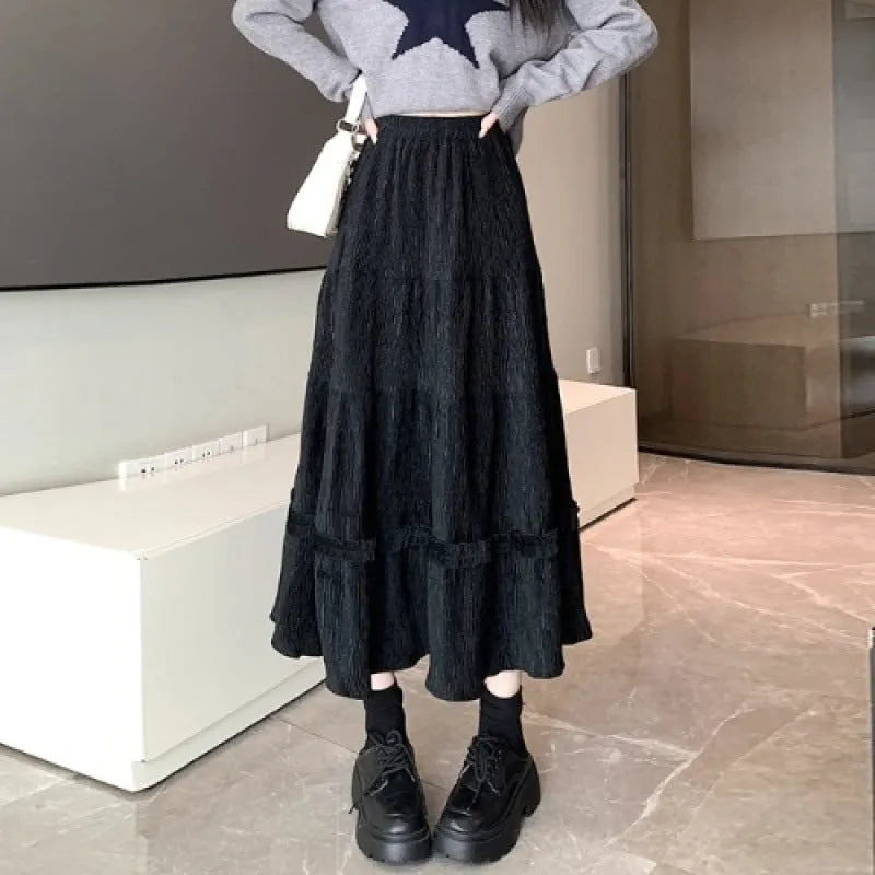Women's milky white corduroy A-line midi skirt with an elastic waistband on a hanger.