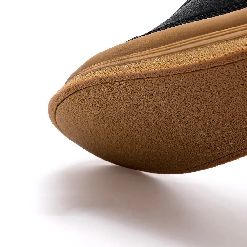 Men's black leather casual shoes with round toe and soft rubber soles shown from side view