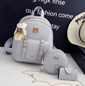 Three-piece women's bag set showing backpack, shoulder bag, and card wallet in matching colour