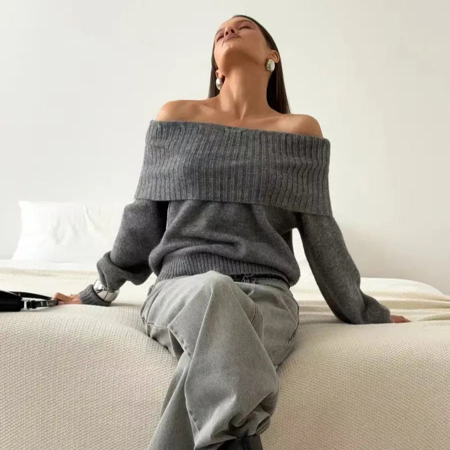 Grey off-the-shoulder sweater with a 3D pattern and strapless design, laid flat.