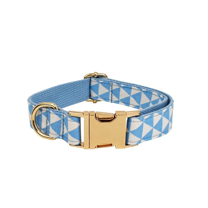 Blue triangular pattern dog harness set with matching leash, collar, and fabric bow accessory