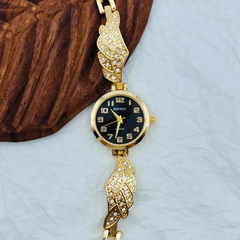 Women's stainless steel fashion watch with round gold dial and vachette clasp.