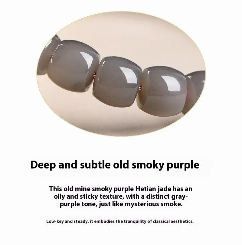 Smokey violet Hetian jade straight cut bead bracelet on a wrist.