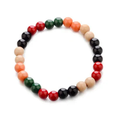 Unisex ethnic-style beaded bracelet with lava stone on a wrist, showing essential oil application.