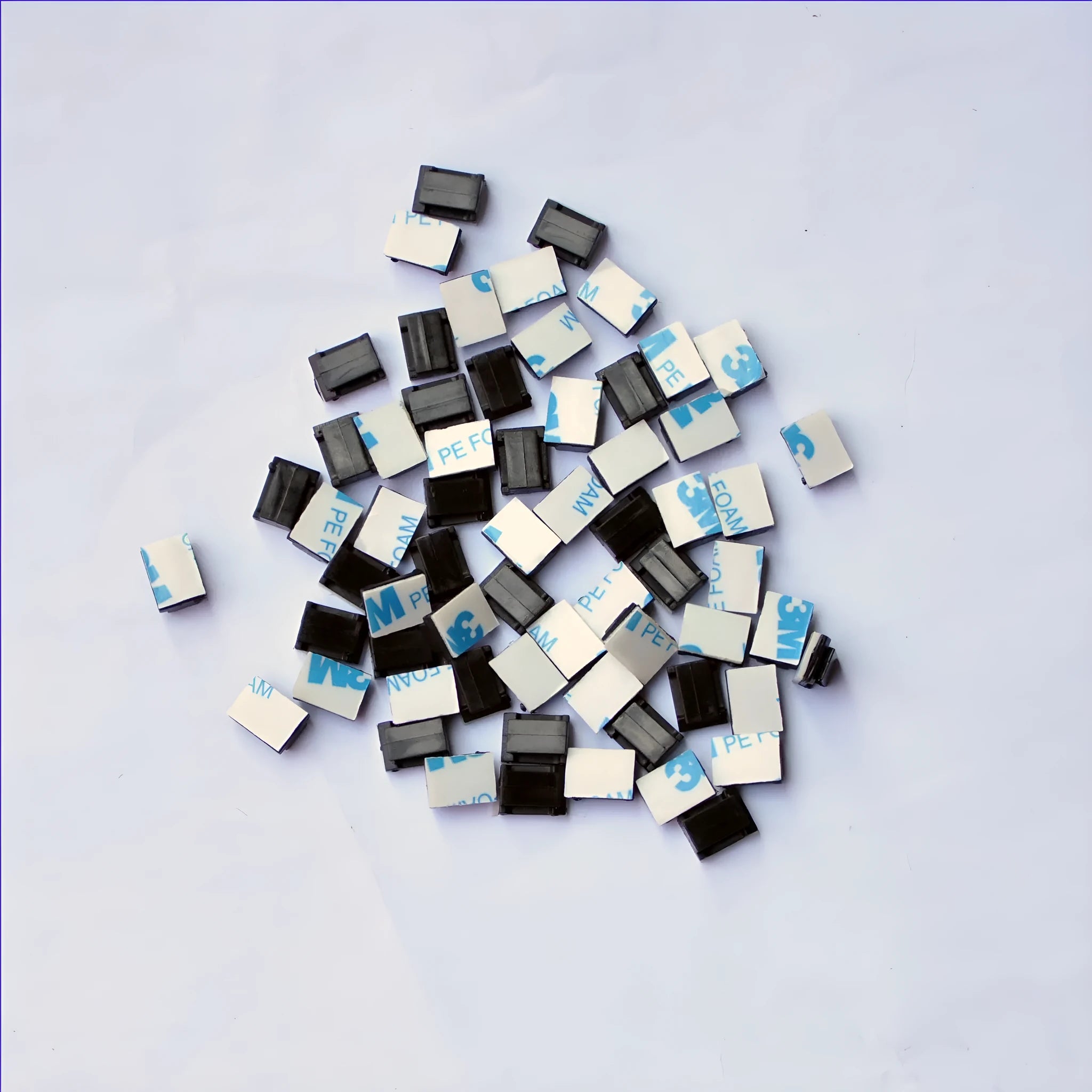 Black PA66 nylon cable management clip for automotive and electronic wiring.