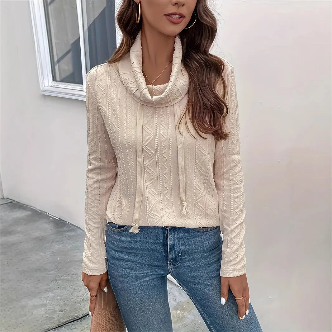 Apricot coloured long sleeve hooded pullover sweater with a drawstring, shown on a hanger.