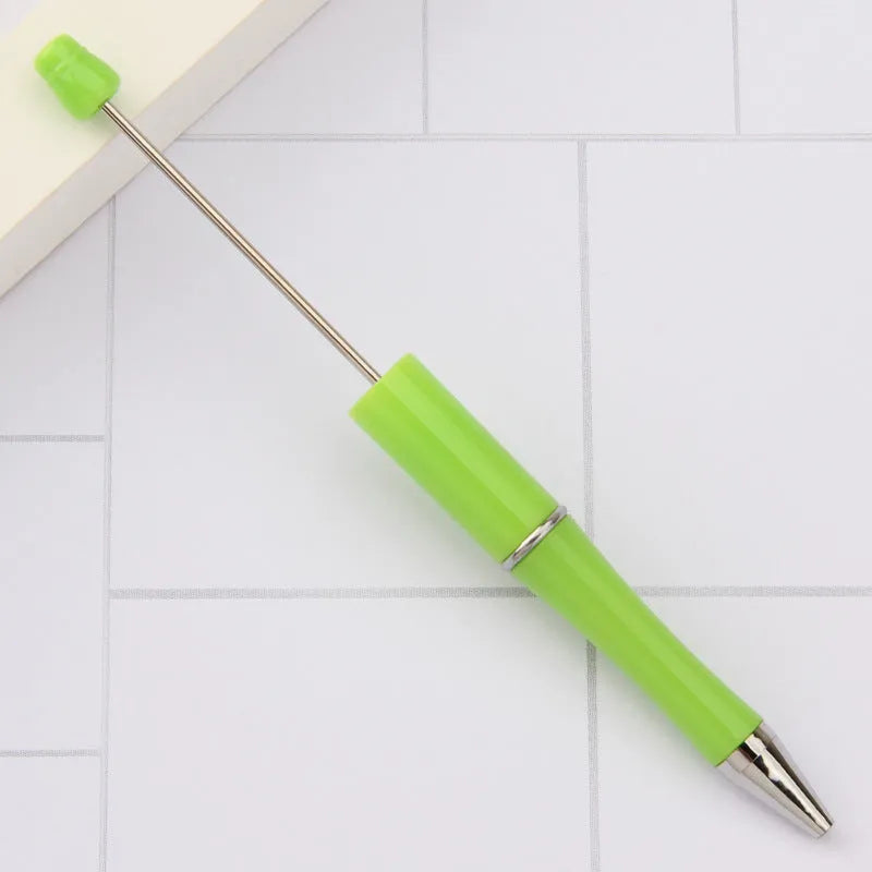 Creative ballpoint pen with multicoloured spinning plastic beads on a steel wire frame.
