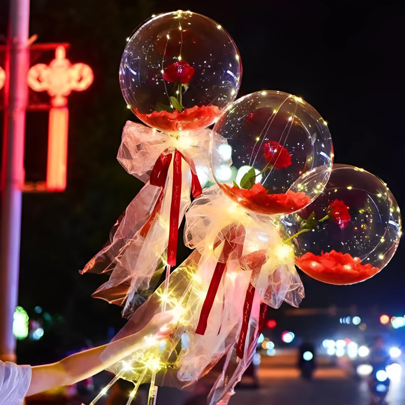 Transparent LED luminous balloon bouquet with artificial rose and glowing light inside, displayed as a DIY kit.
