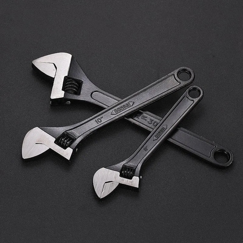 Stainless steel adjustable open-end wrench with blackened finish showing adjustment mechanism and four size options