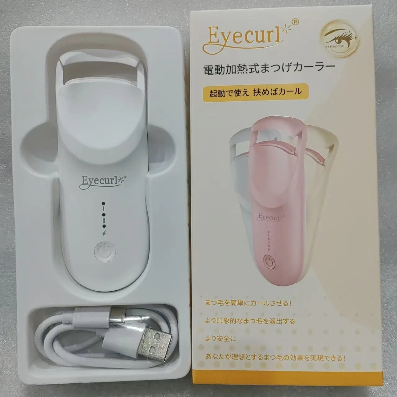 Plastic electric heating eyelash curler with USB cable in cream white, pink, or apricot.