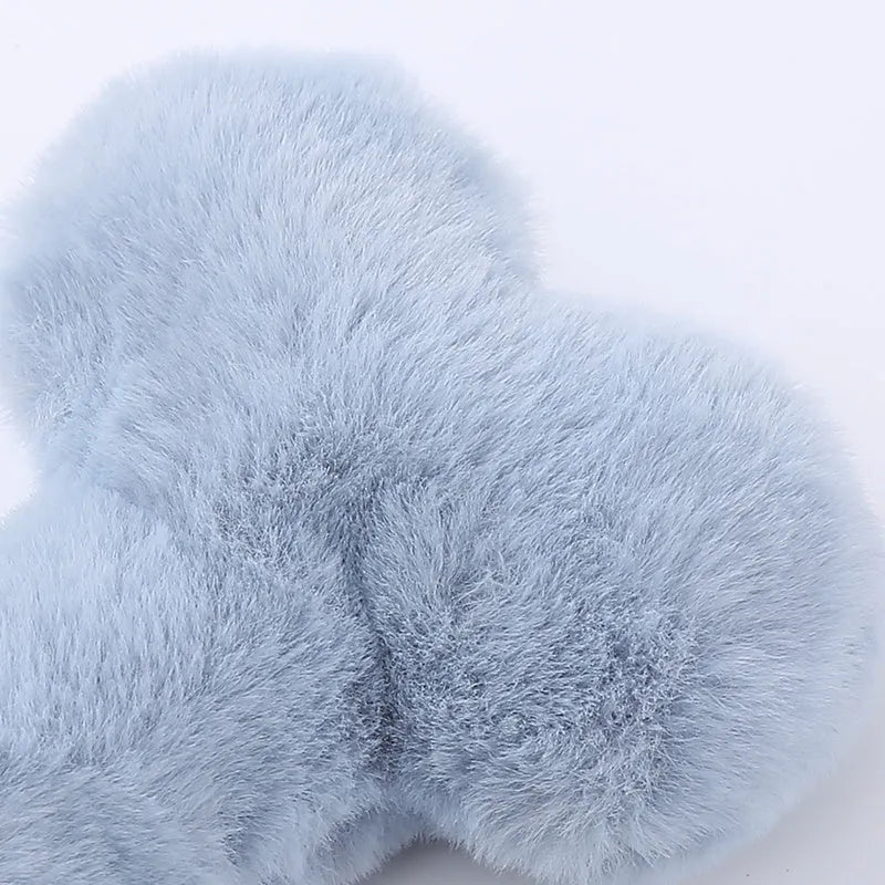 Cute love bone shaped plush dog toy in blue, pink, and yellow colours for interactive chewing play.