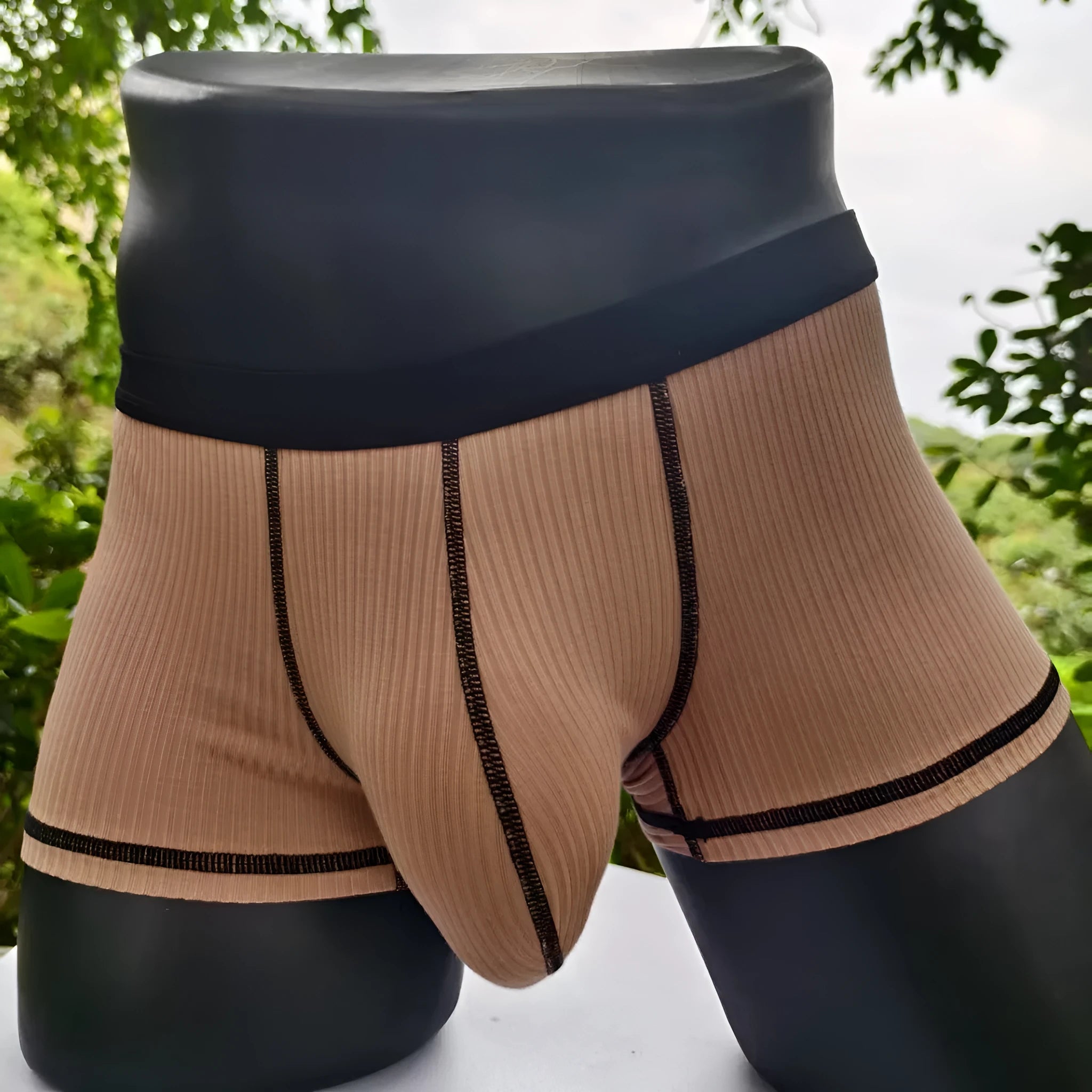 Solid-colour men's boxers in breathable fibre fabric on a size chart.