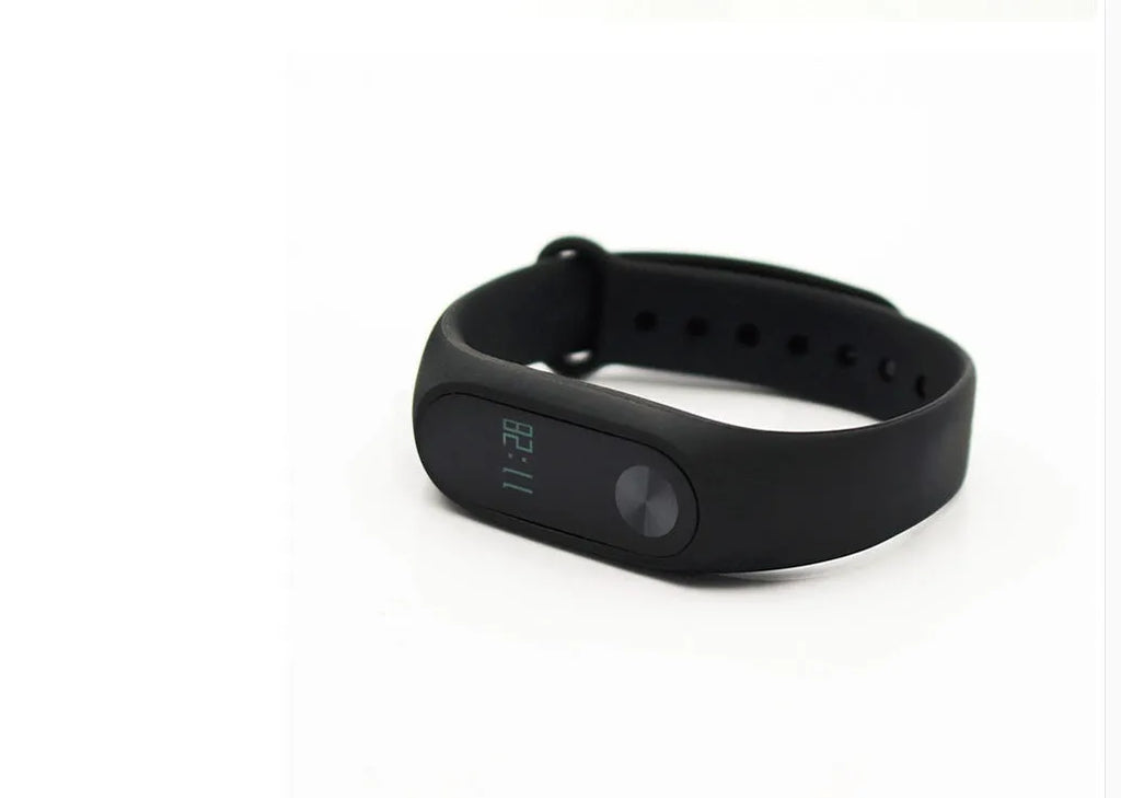 Black Xiaomi Mi Band 2 fitness tracker with OLED screen on a wrist.