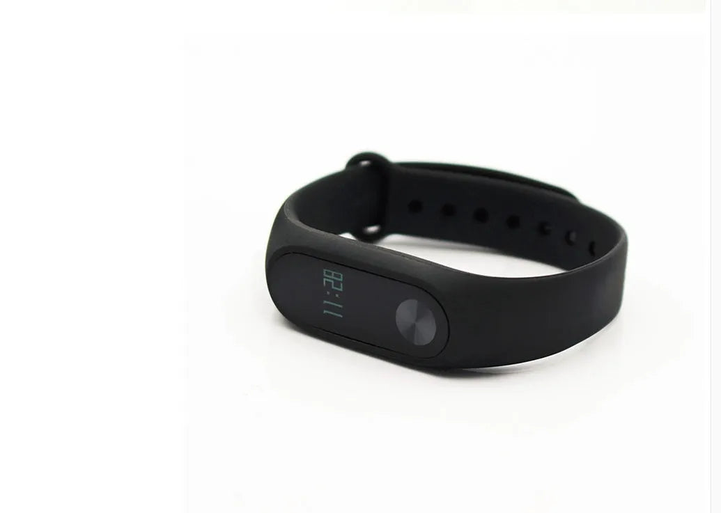 Black Xiaomi Mi Band 2 fitness tracker with OLED screen on a wrist.