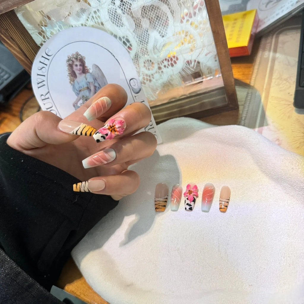 Set of nail art stickers showing zebra pattern and lily flower designs with embossed texture.