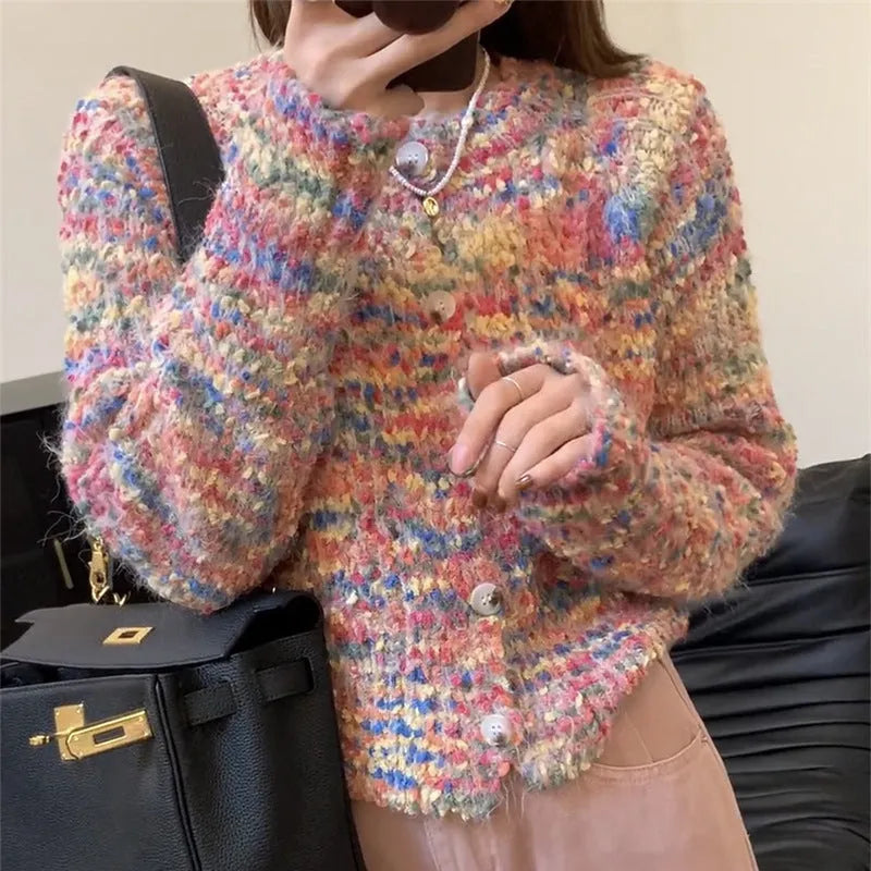 Pink and green retro style slim-fit knitted cardigan sweater on a hanger.