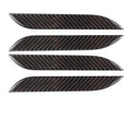 Four carbon fibre adhesive door handle protection stickers for Tesla Model S interior.