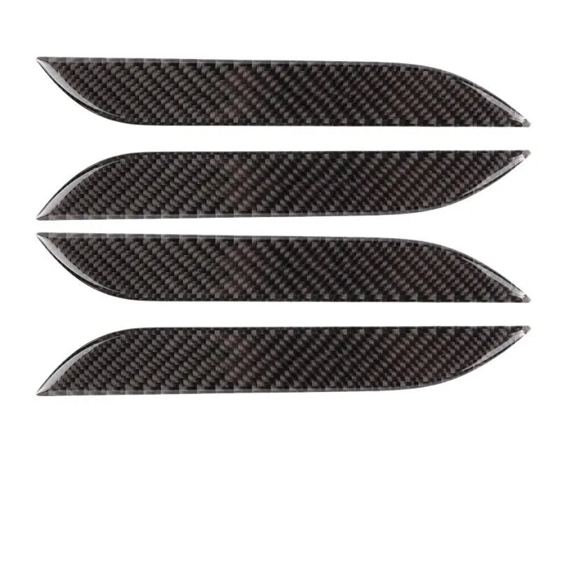 Four carbon fibre adhesive door handle protection stickers for Tesla Model S interior.