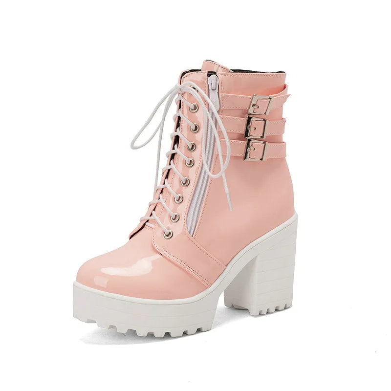Women's black thick-heeled lace-up ankle boots with a round toe and rubber sole on a waterproof platform.
