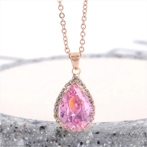 Pink water drop geometric necklace with rose gold electroplating and rhinestone detailing on alloy pendant