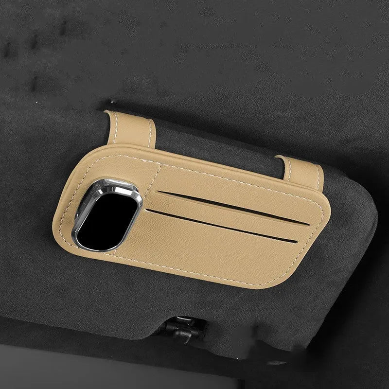 Beige leather car sun visor card holder with a glasses clip shown installed on a vehicle visor.