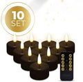 Four black LED flameless tealight candles showing their size and flickering flame effect.