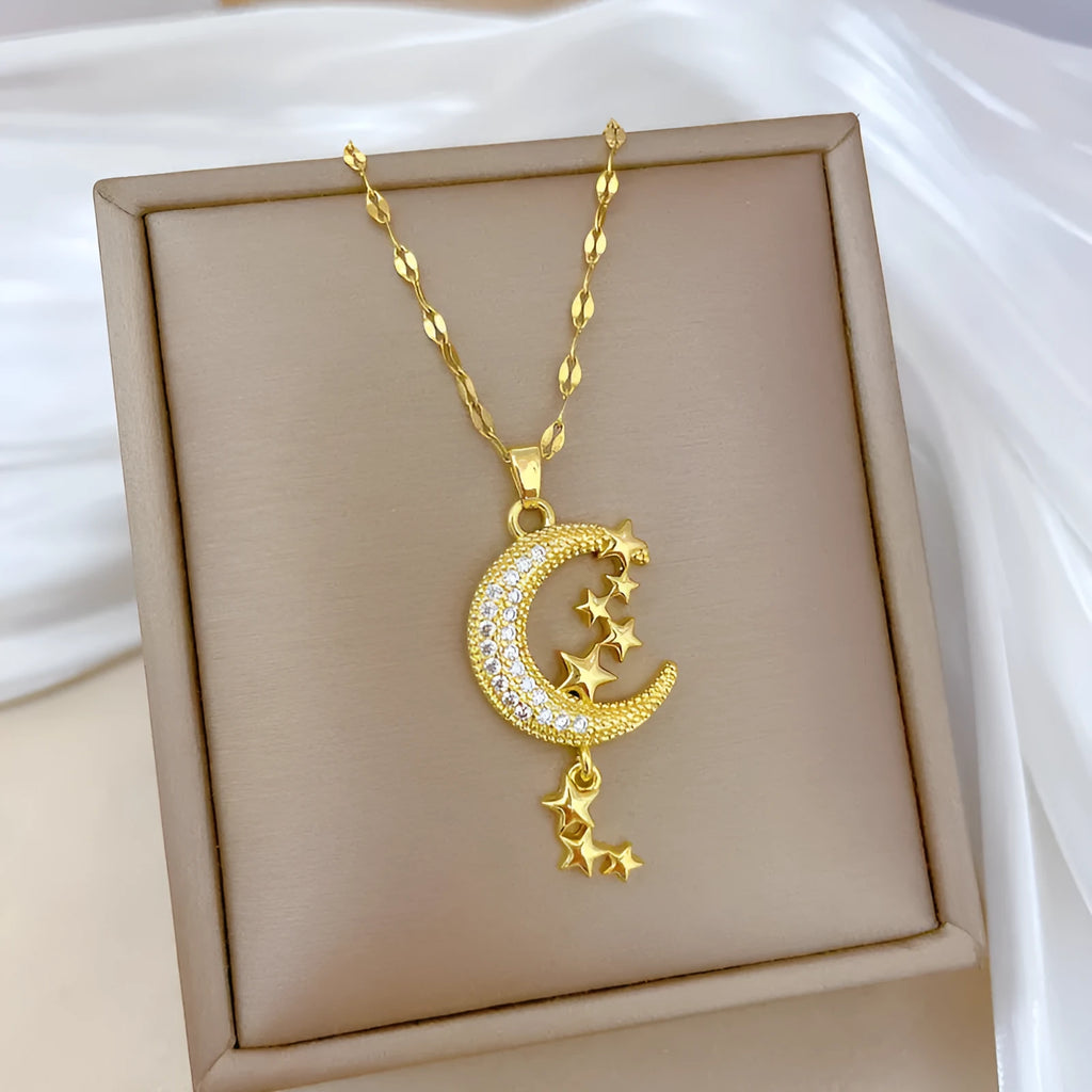Moon-themed necklace with geometric copper pendant featuring tassel and diamond details on stainless steel chain