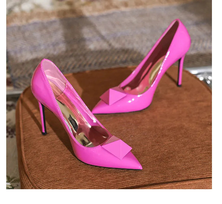 Women's pink pointed toe stiletto high heels with buckle closure and patent leather uppers