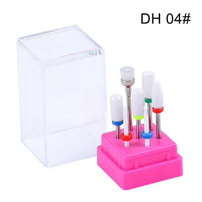 Set of seven tungsten steel nail drill bits and a brush in a transparent storage case.