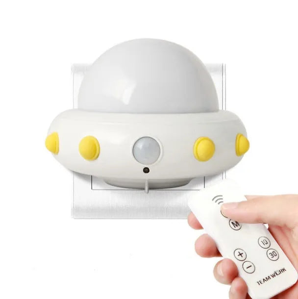 Remote control UFO shaped bedside night light in blue, pink, or white colour.