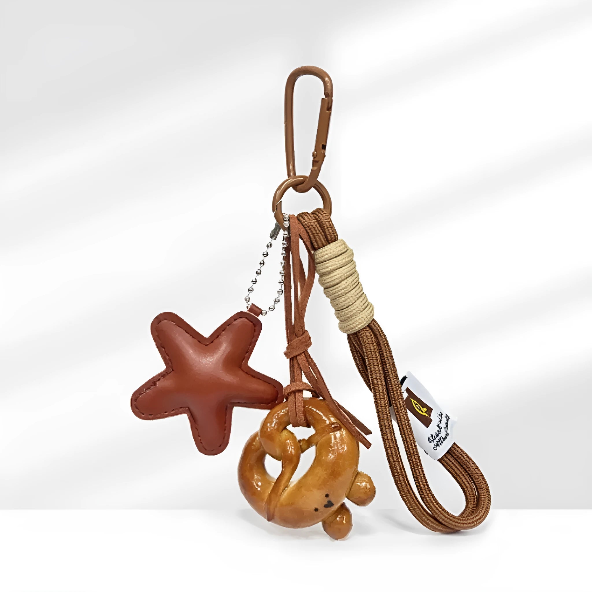Handmade brown star resin handbag pendant with cartoon soda bread design on a brown strap