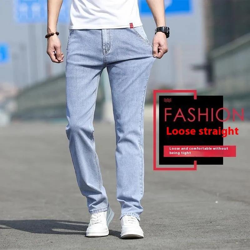 Man wearing smoky grey straight leg men's jeans with a low waist and zip fly.