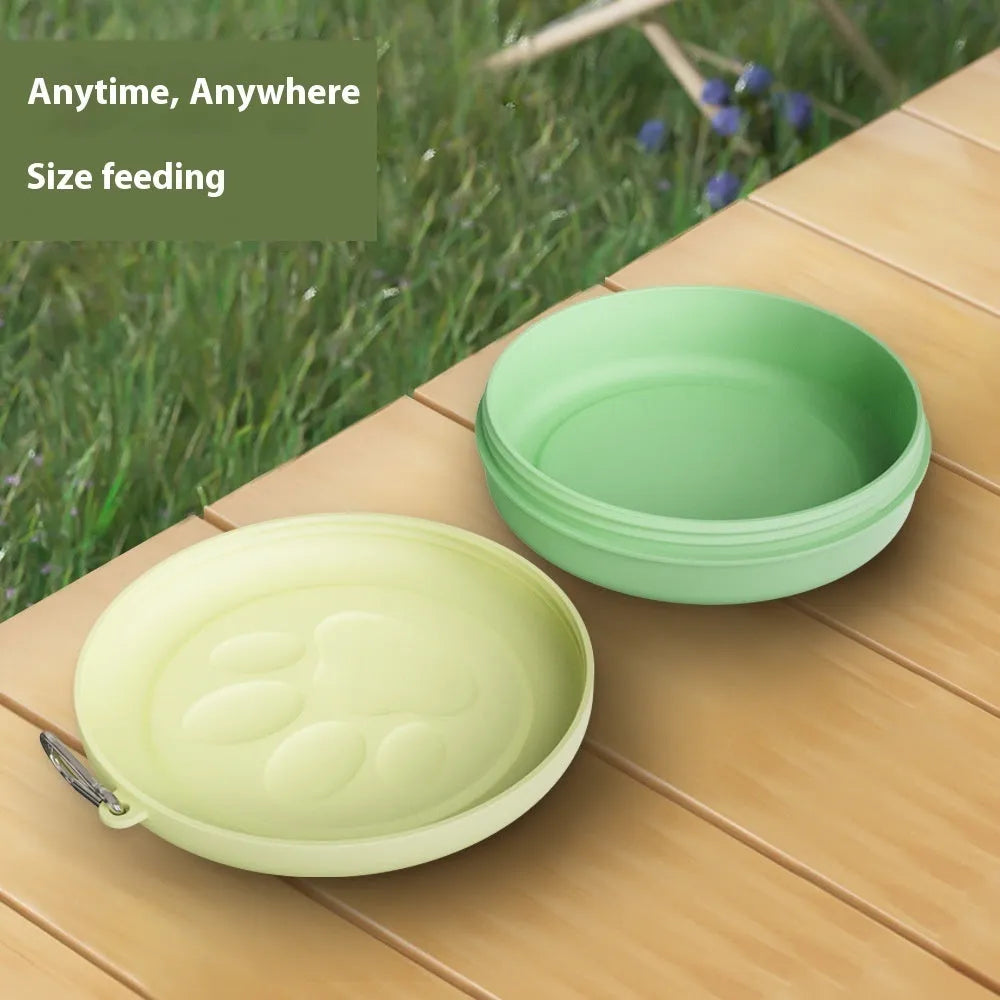 Collapsible silicone dog bowl in light pink and green colours showing portable feeding design