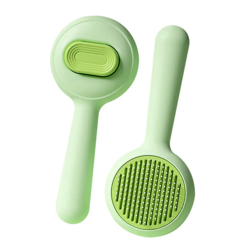 Green pet grooming brush with stainless steel pins and non-slip handle for cat and dog hair removal.